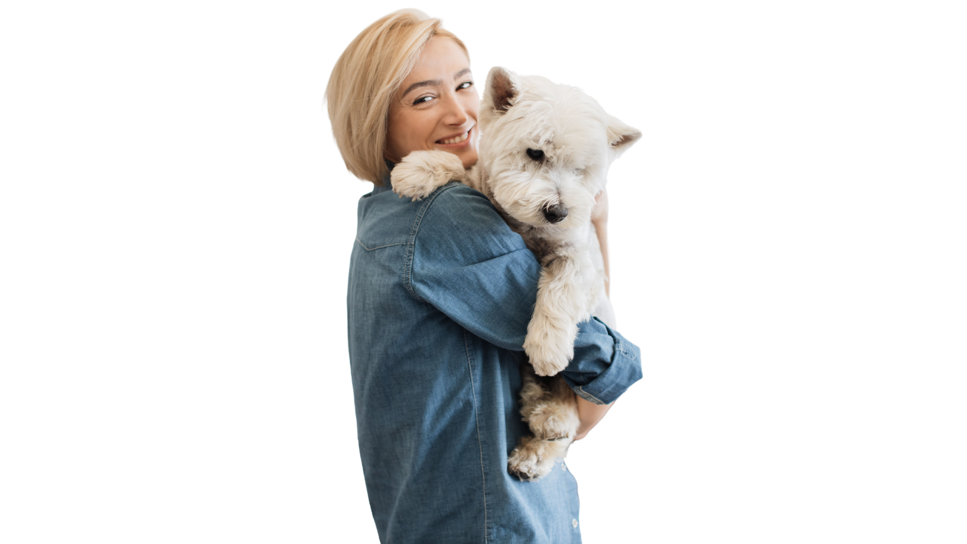 Smiling woman holding a white puppy at an animal hospital.